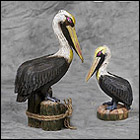 Romantic Pelican Couple Sculptures black, brown pelican statues