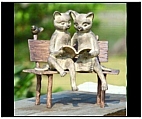 Boy and Girl Reading Cats on a Bench